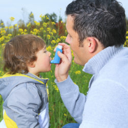 child with asthma being helped by father first aid for children