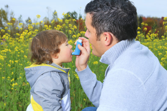 child with asthma being helped by father first aid for children