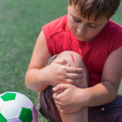 child with open wound on knee