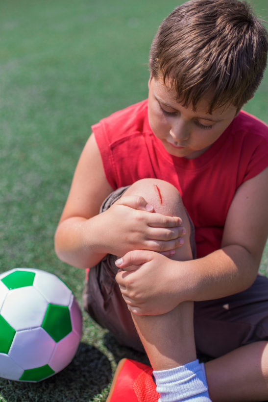 child with open wound on knee